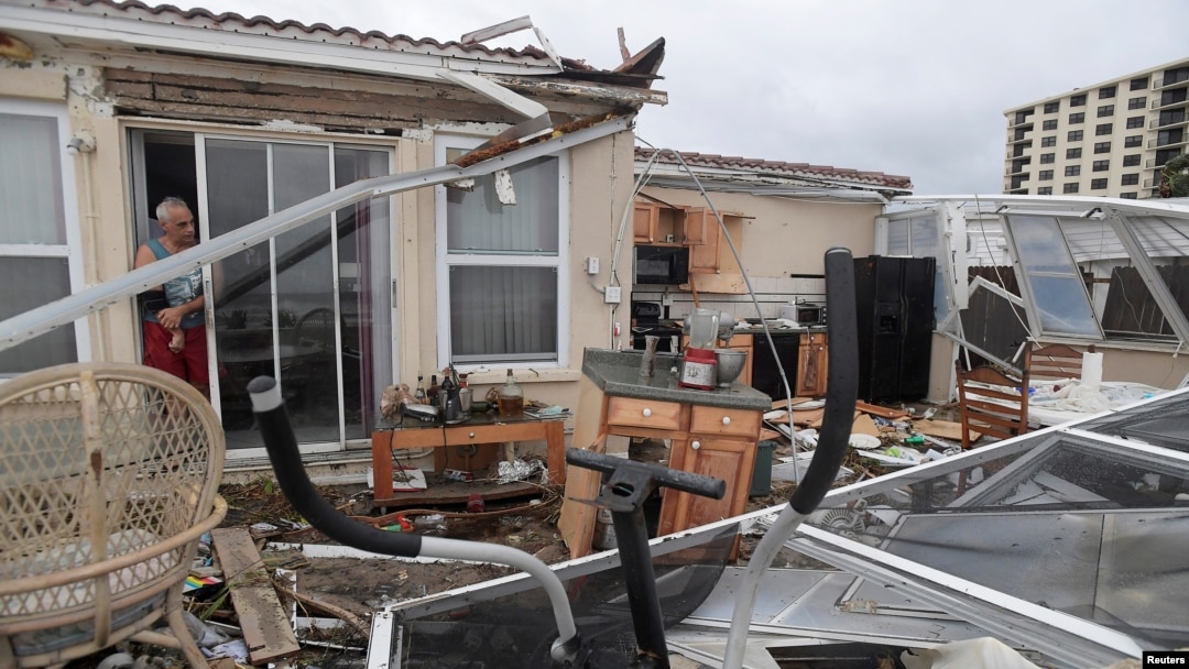  Homeowner Joe Lovece surveys the damage to the kitchen at the back of his oceanfront home after the eye of Hurricane Matthew passed Ormond Beach, Florida, on October 7, 2016. Lovece rode out the storm as waves took away the room at the back of his home. 