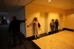 People brace themselves against a wall during an earthquake, in Mexico City, June 23, 2020.